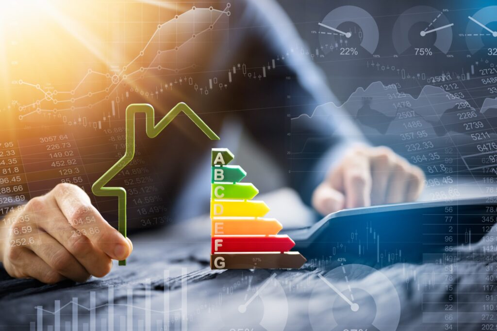 Close-up,Of,A,Businessman,Using,Calculator,Holding,Outline,Of,House